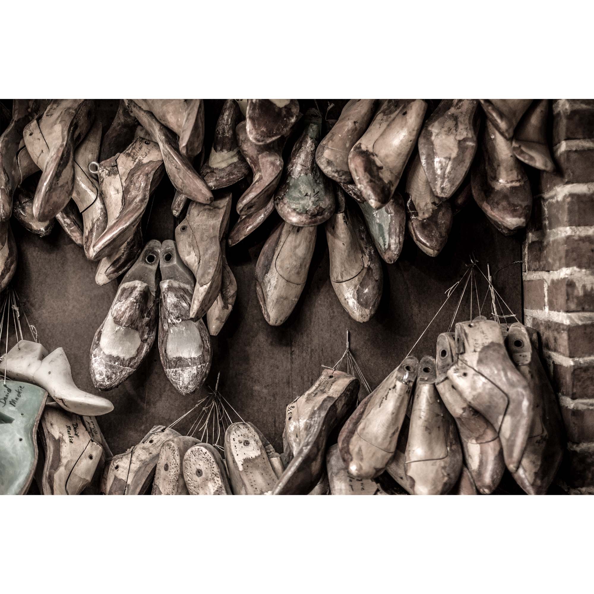 Tadd Myers, Making Boots - boot molds hanging on the wall in the shop.
