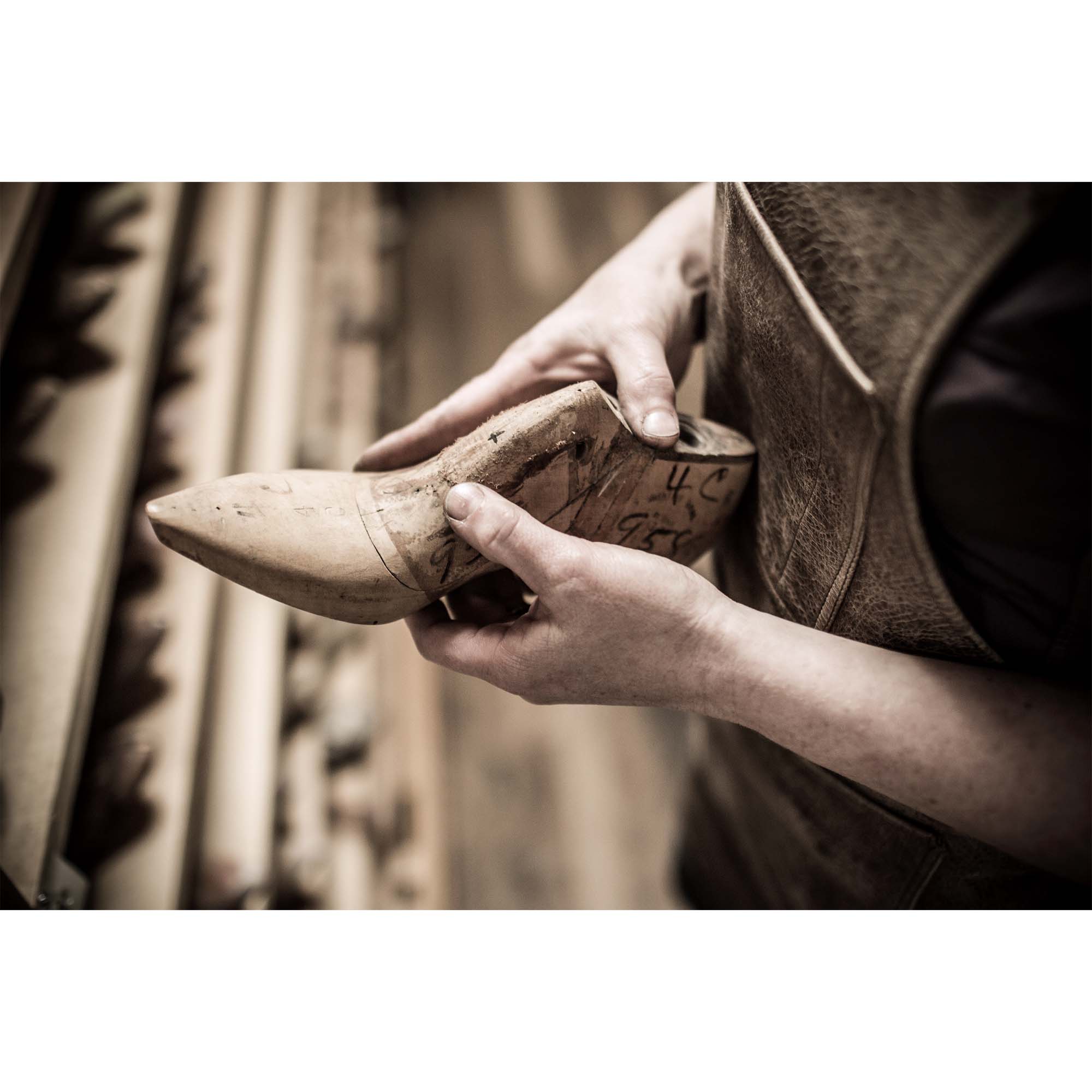 Tadd Myers, Making Boots, choosing the boot mold - example photo on a wall.